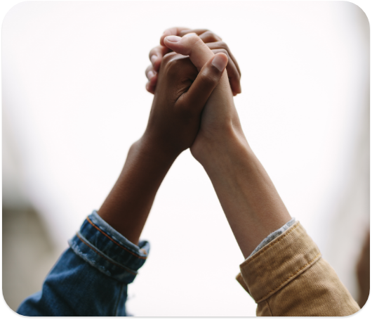 Two different people's hands grasped together