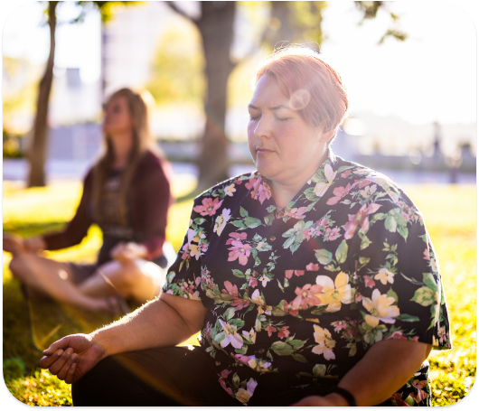 Students meditating outside