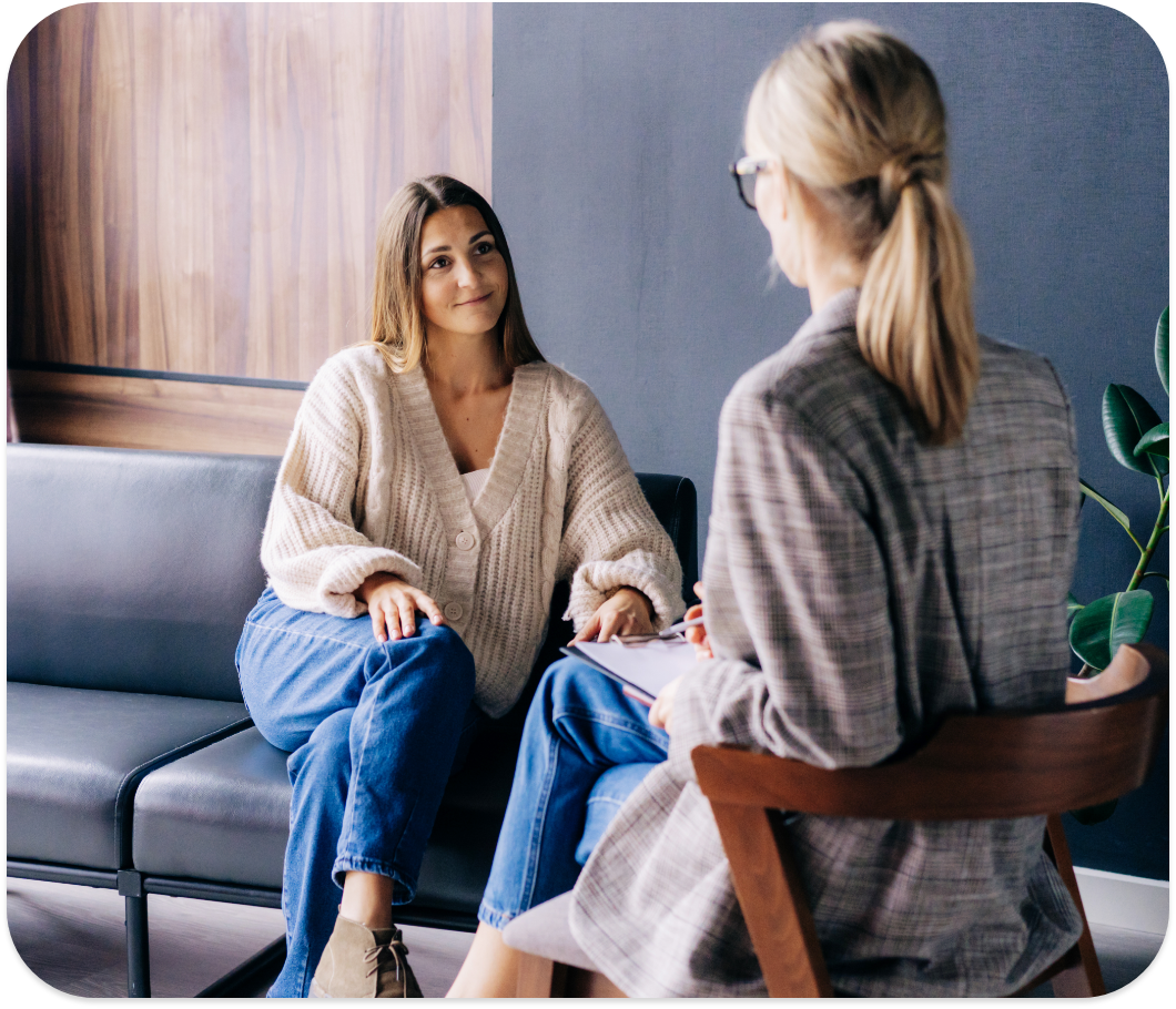 A counselor sitting with a client in a discussion.