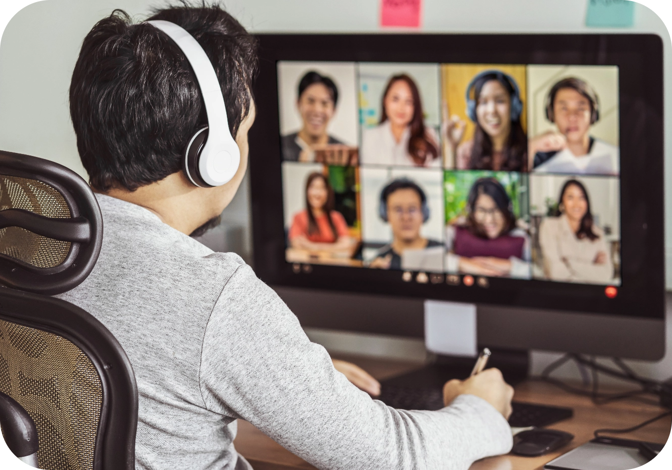 man looking at screen full of people