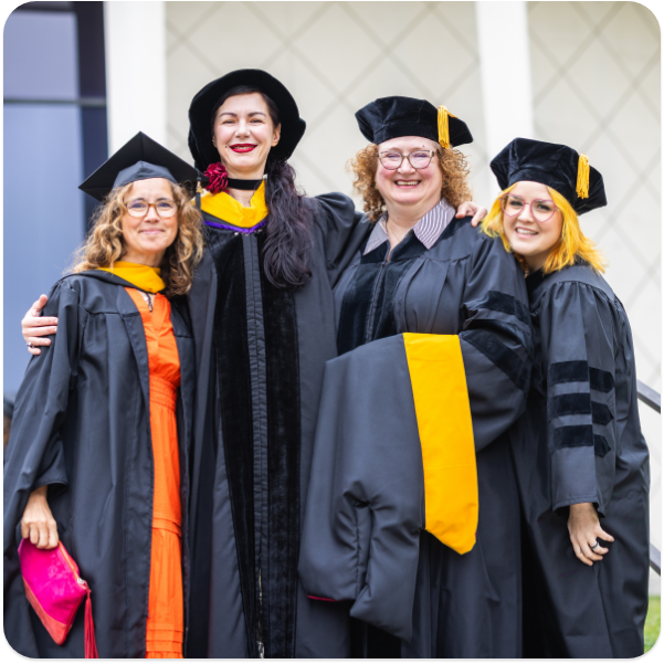A group of students and teachers at graduation