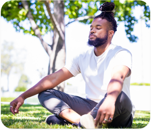 A person meditating outside