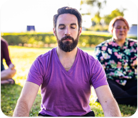 People outside doing meditation.