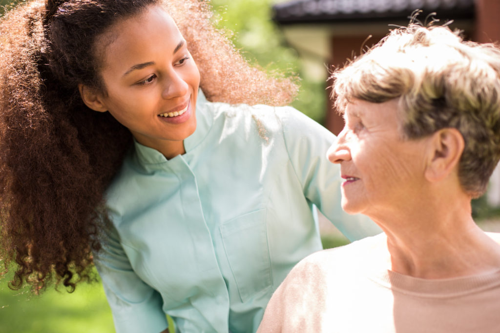 young woman interacting with old woman