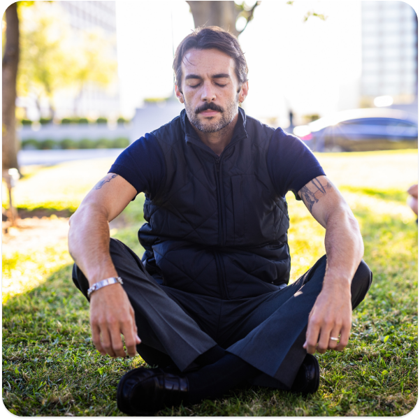 man in park meditating
