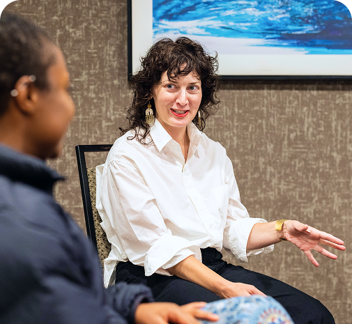 woman in a discussion with another student